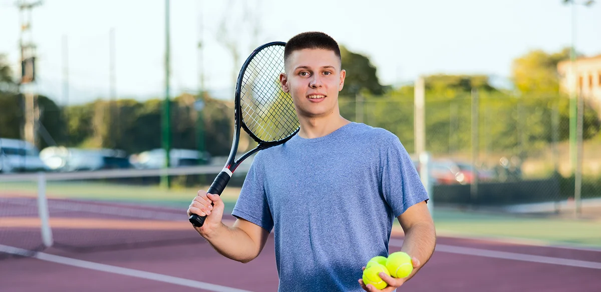 Student playing tennis